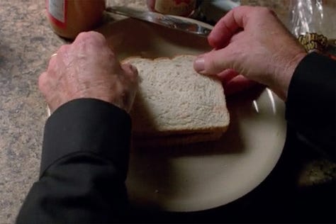 Bryan Cranston’s Walter White cutting of the crusts of his white bread peanut butter and jelly sandwich in Breaking Bad, cutting off crusts like the lovable maniac he is. 