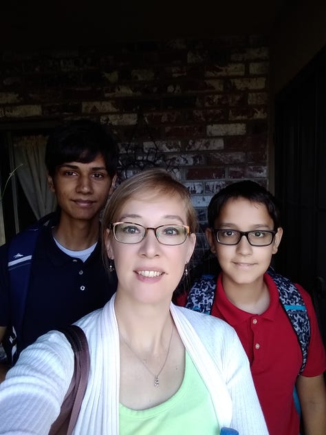 children in school uniform on front porch