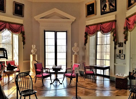 Some rooms inside Monticello, showing the windows and lots of lights. The draperies are red.