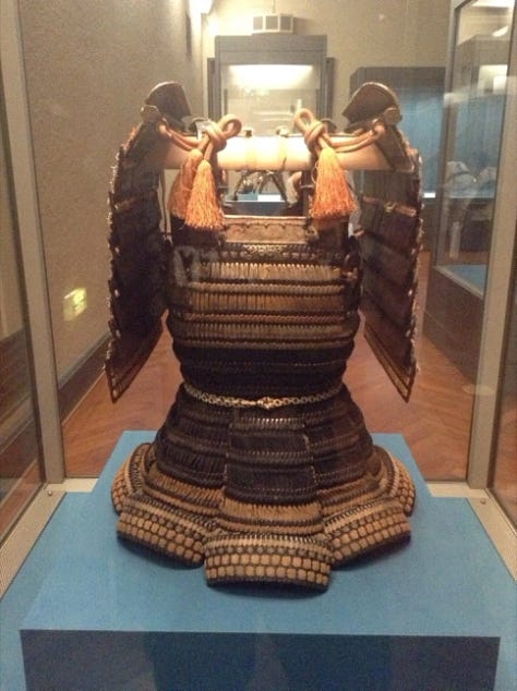 Japanese armour, a statue and a painting of man on horse