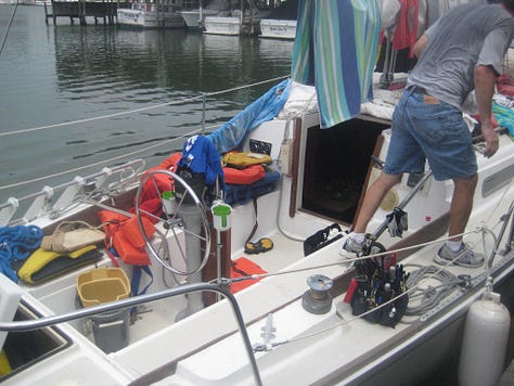 A sailboat with many items draped out to dry after a storm