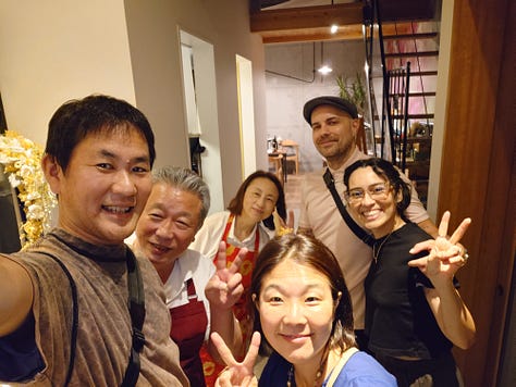 9 pictures of Jackson, his wife, his Japanese cousin, Eikichi, and Eikichi's wife, Megumi, together, visiting the ancestral grave in Iyo City, walking around Matsuyama, eating dinner with Uncle Kazuya, leaving the train station, eating Oden in Ginza, posing with Lin-Chan, the Japanese poodle, and pictures of Jackson and Erika taking pictures of the Tokyo skyline