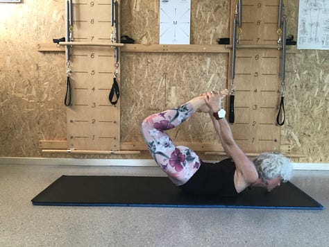 woman on Pilates mat executing the Rocking