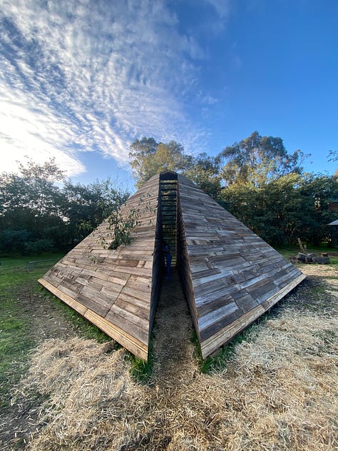 Series of images of large timber pyramid structure in open space as fire takes hold and it burns to the ground