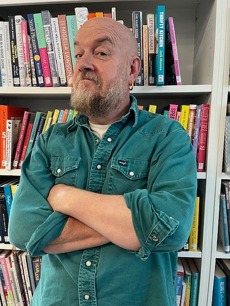 Three photos of comedian George Egg standing in front of a bookshelf of cook books, wearing a green shirt and with his arms crossed.