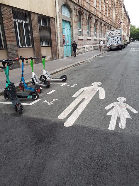 A street closed off to vehicles with railings.