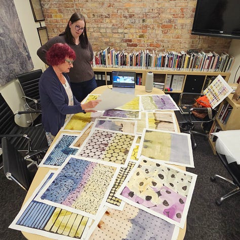 Selection committee sorting through the 21 paintings to decide which one best represents the historic preservation of the King Con Ore Bin