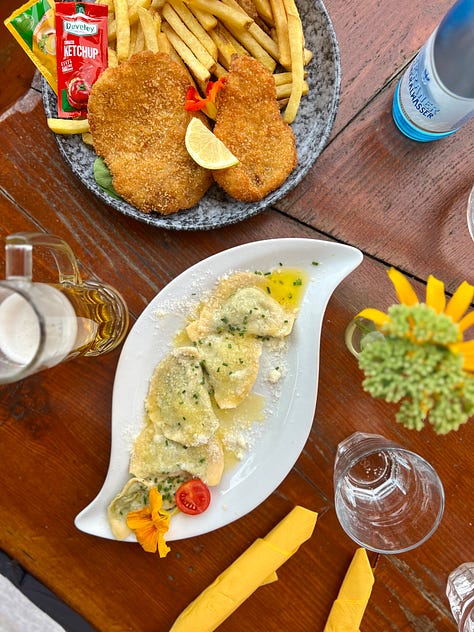 Sample of meals from the Italian Dolomites, including polenta with mushrooms, homemade ravioli with spinach, and canederli with cabbage salad