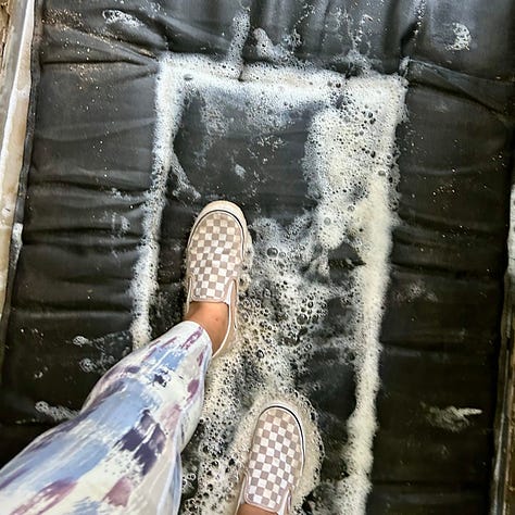 Three images show Nicole's trip into Mammoth Cave. In the first, a large group of people descend around 100 steps into the cave. In the second, the dimly lit Mammoth Passage is visible, with a group of tour-takers experiencing the view. In the third image, Nicole's pink Vans slip-ons step on a sudsy, black mat.