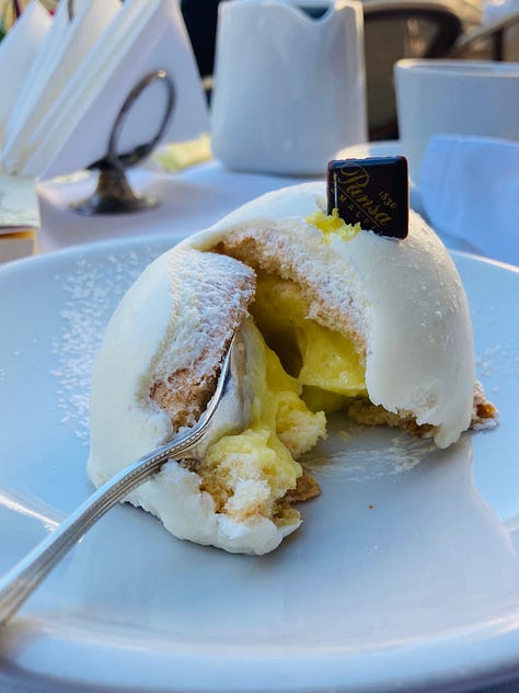 Images of a pastry known as Lemon Delight made in Amalfi, Italy. About the size of a tennis ball it is white in colour with a piece of chocolate on top. 