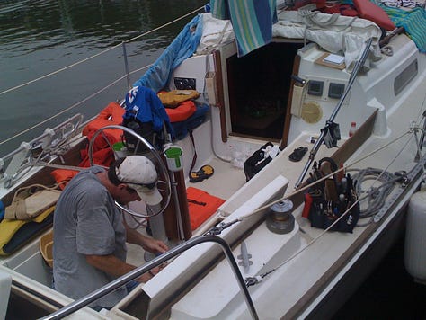 A sailboat with many items draped out to dry after a storm