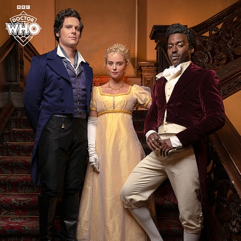 Pics 1 and 2 L-R: Jonathan Groff, Millie Gibson and Ncuti Gatwa on set for the upcoming series of Doctor Who. They are wearing regency-style clothing and standing together in the stairwell of an old manor. Pics 3-5 are additional pics of Gibson in a garden wearing a gold-coloured regency style dress with elbow-length white gloves.