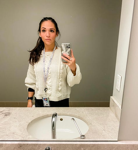 Mirror selfie photo of woman in an elevator wearing a mask and social distancing markers on the floor of the elevator, mirror selfie of a woman, mirror selfie of a woman