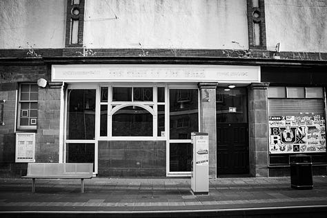 Black and white photographs of The foot of the Walk after it closed. The sign has been removed.