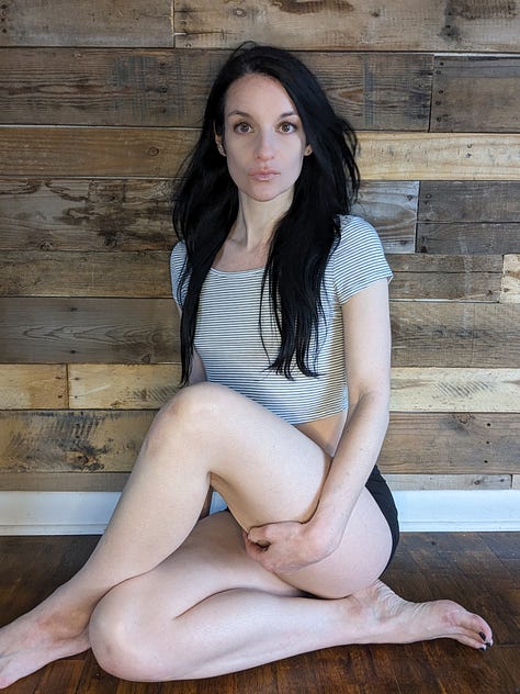 Beautiful woman sitting on living room floor.