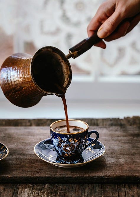 A whimsical wedding dinner set up under a canopy of trees. A loungeroom AI generated image with a center fireplace, mustard velvet couches and round windows. A photo of a china teacup with coffee pouring in