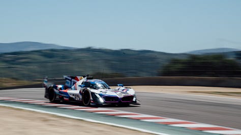 The No. 24 and No. 25 BMW M Team RLL racecars speed across Laguna Seca during the IMSA Monterey round in May 2025. Photos by Walter Fulbright.
