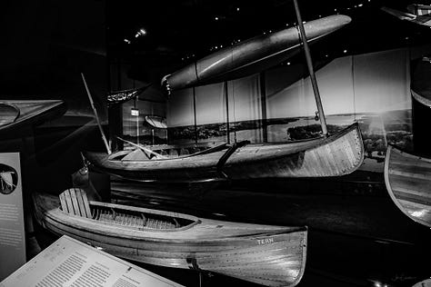 A collection of canoes, kayaks and other vessels