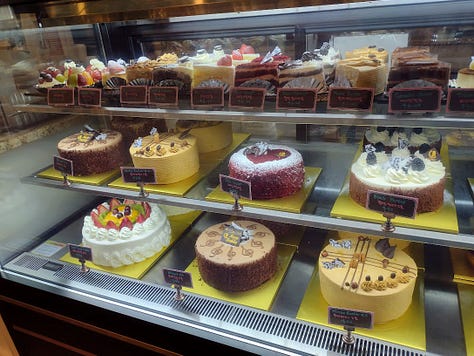 Bakery case, buns, interior of bakery with chandeliers