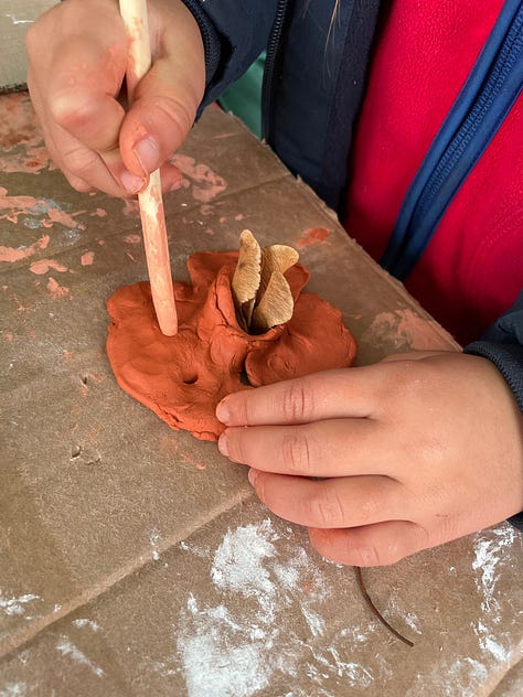 craft table with clay and natural materials, face painting and flower bulbs to plant