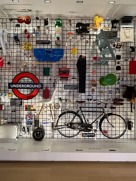 A selection of items on the wall at London's Design Museum including a yellow lemon press, an iconic Phillipe Starck bottle opener, some ice cream scoops, spoons, a hanging wall of classic deisgns and a Chemex pour over glass coffee maker.