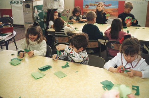 Children making paper shamrocks for St. Pat's Day