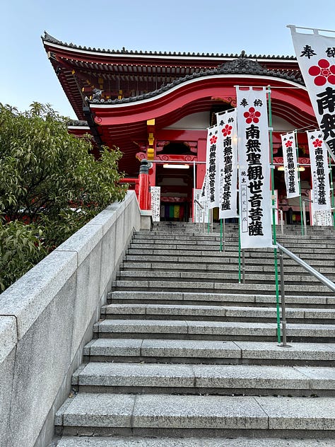 Pictures of soba, Tokyo citscapes, robots, Tokyo girls dressed in Maid outfits, my hand on LB's shoulder, Tokyo Tower, Robot greeters, two Issey Miyake mannequins, a cabinet of Japanese food supplies, and the side entrance of Sensoji Temple