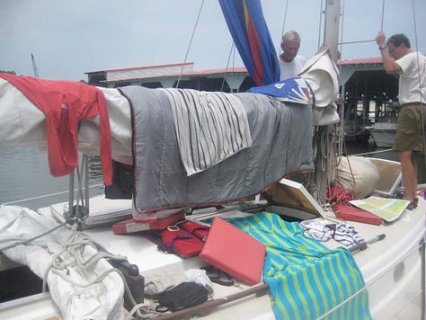 A sailboat with many items draped out to dry after a storm