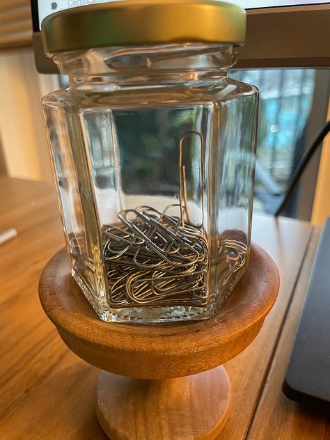 Paper clips accumulating over time in a small mason jar