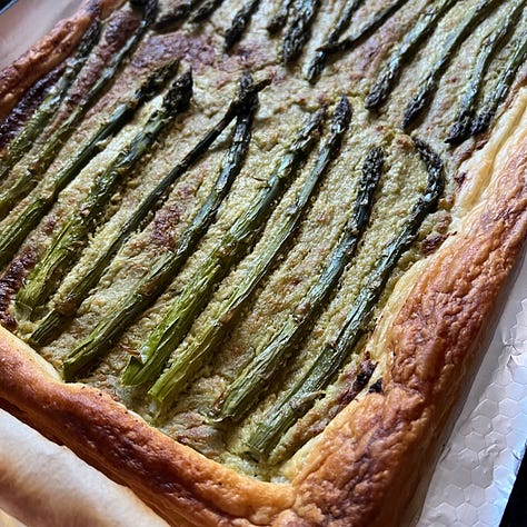 An asparagus tart, asparagus and crumbled Parmesan, asparagus, crispy smashed potatoes and green dip