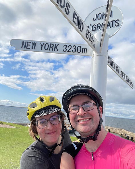 Jem and Jack, in cycle helmets stand in front of the John O'Groats sign. A picture of a highland cow, and a firey sunset about the sea burns with a bright orang