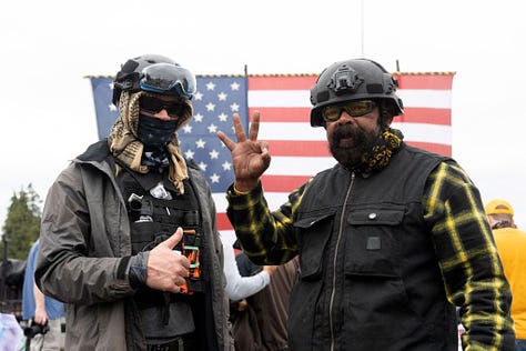 Photos of members of the Proud Boys making the "OK" sign