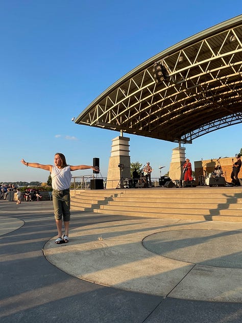 people sitting in lawn chairs or dancing at a concert