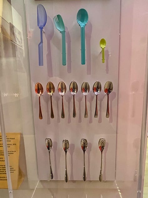 A selection of items on the wall at London's Design Museum including a yellow lemon press, an iconic Phillipe Starck bottle opener, some ice cream scoops, spoons, a hanging wall of classic deisgns and a Chemex pour over glass coffee maker.