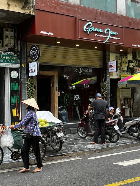 the Religion Publishing House, a pho stand, people cooking meat on the street for banh mi and bun cha, and Craft Link, a social enterprise shop encouraging economic development and helping rural women support themselves by "seeking new markets for traditional artisans."    