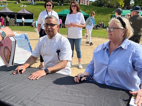 White tent in a town park, portrait of chef Will Devlin, restauranteur Atul Kochhar with Rosemary Shrager 