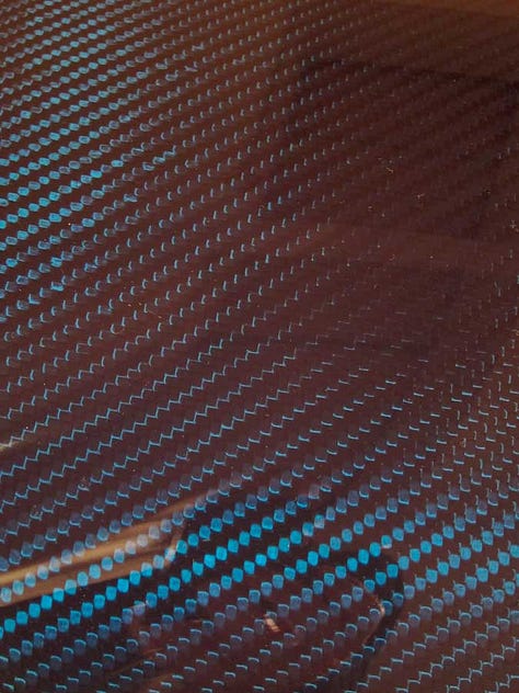 close up photo of Bugatti Veyron carbon fiber laquer finish