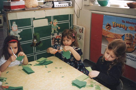 Children making paper shamrocks for St. Pat's Day