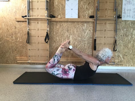 woman on Pilates mat executing the Rocking