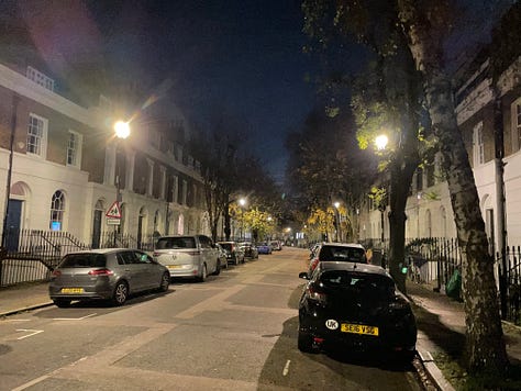 A variety of pictures of London streets at night. One shows a bus stop with people waiting at it. Another a bike locker and other bike parking. Another shows a van and car for hire. The rest show street scenes with Georgian town houses and empty streets lit by street lights