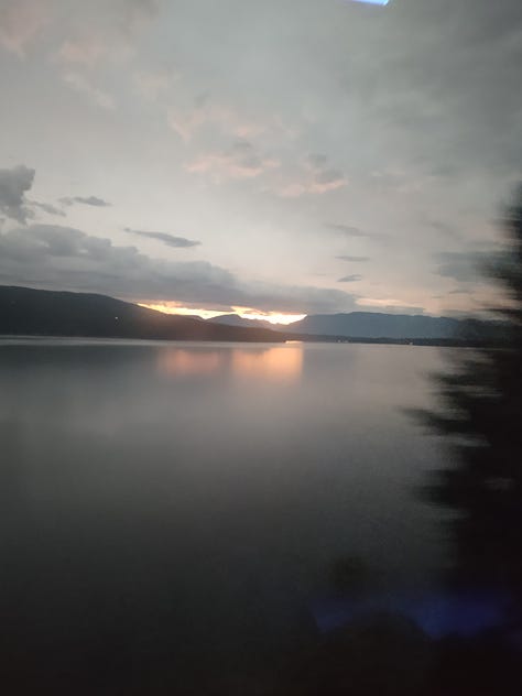 The first image shows a mountain gully with a river running through it. The second is a sunset over a large lake. The third shows another river with a rocky bank on one side and coniferous forest on the other