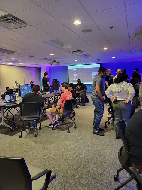 Image 1: Community members chatting and testing out games on display. Image 2: Two women sitting in front of a game called Torso Tennis. Image 3: Heather Chandler at front of the room talking about game production.