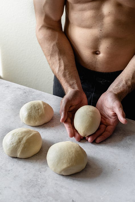 Shirtless baker in black pants making vegan milk bread loaves