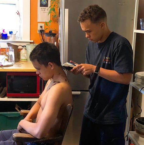 11-year-old holding an electric drill celebrates building a cart, teenager trims his brother's hair, 17-year-old cooks at the stove