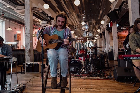 Five stills from Griffin Moyer's performance at Acme Radio Live in the main bair area of Acme Feed & Seed. Some members of the band are also featured.