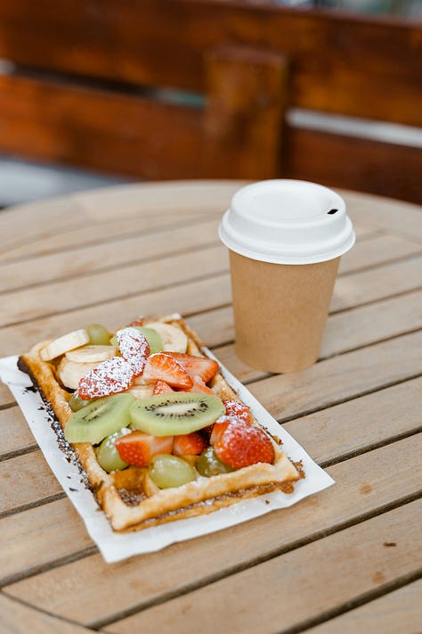 six images; a waffle with fruit and cup of coffee, a strawberry tart, a dark blue tiled wall with the words 'messy is good' in golden letters, a basket of small bread rolls, two rustic loaves on a wooden cutting board and finally two scoops of luscious ice cream on a cone in a cone stand one scoop vanilla with a scoop of chocolate ice cream on top
