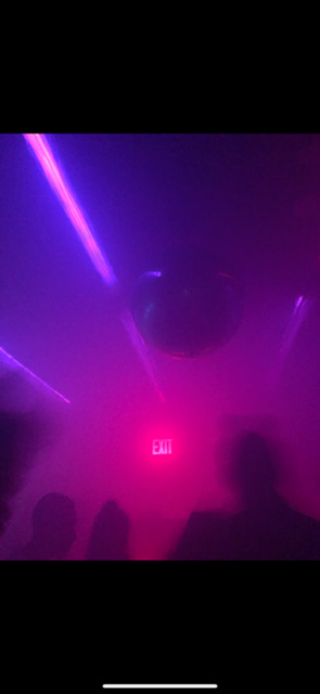 blue or purple lights in foggy dance floors with silhouettes of people in foregrounds