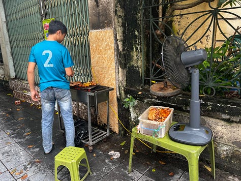 the Religion Publishing House, a pho stand, people cooking meat on the street for banh mi and bun cha, and Craft Link, a social enterprise shop encouraging economic development and helping rural women support themselves by "seeking new markets for traditional artisans."    