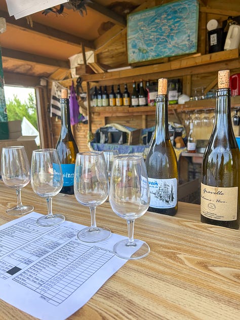 Wine glasses and bottles at a roadside wine stand