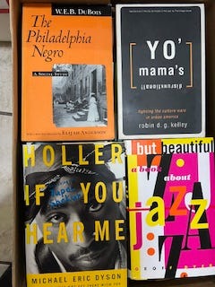 A selection of books in nine images. Each image has several books all lined up together in a row. One is a top-down look at four books that features their covers instead of their spines. Titles include:  W.E.B. Du Bois' "The Philadelphia Negro," "Between Past and Future" and "Human Condition" by Hannah Arendt, "Middle Passages: African American Journeys to Africa," 1787-2005," Michael Eric Dyson's "Holler If You Hear Me," and "City Schools and the American Dream: Reclaiming the Promise of Public Education" by Pedro A. Noguera and James A. Banks